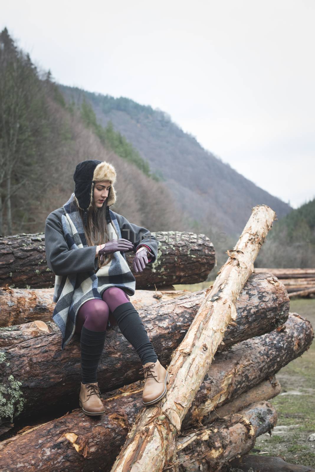 Young woman on wood logs