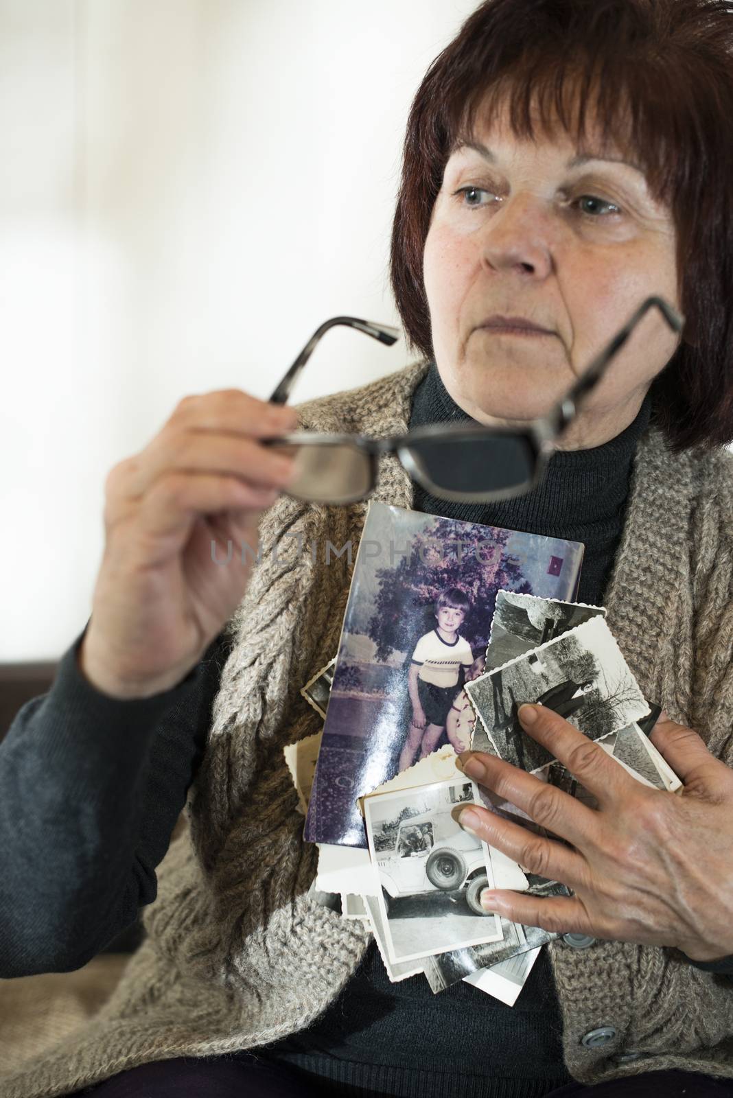 Senior woman and old photos by deyan_georgiev