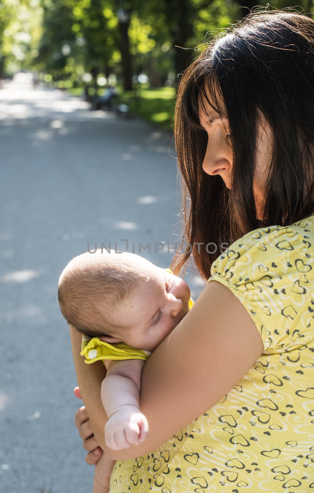 Women and baby in a park. Sunny day