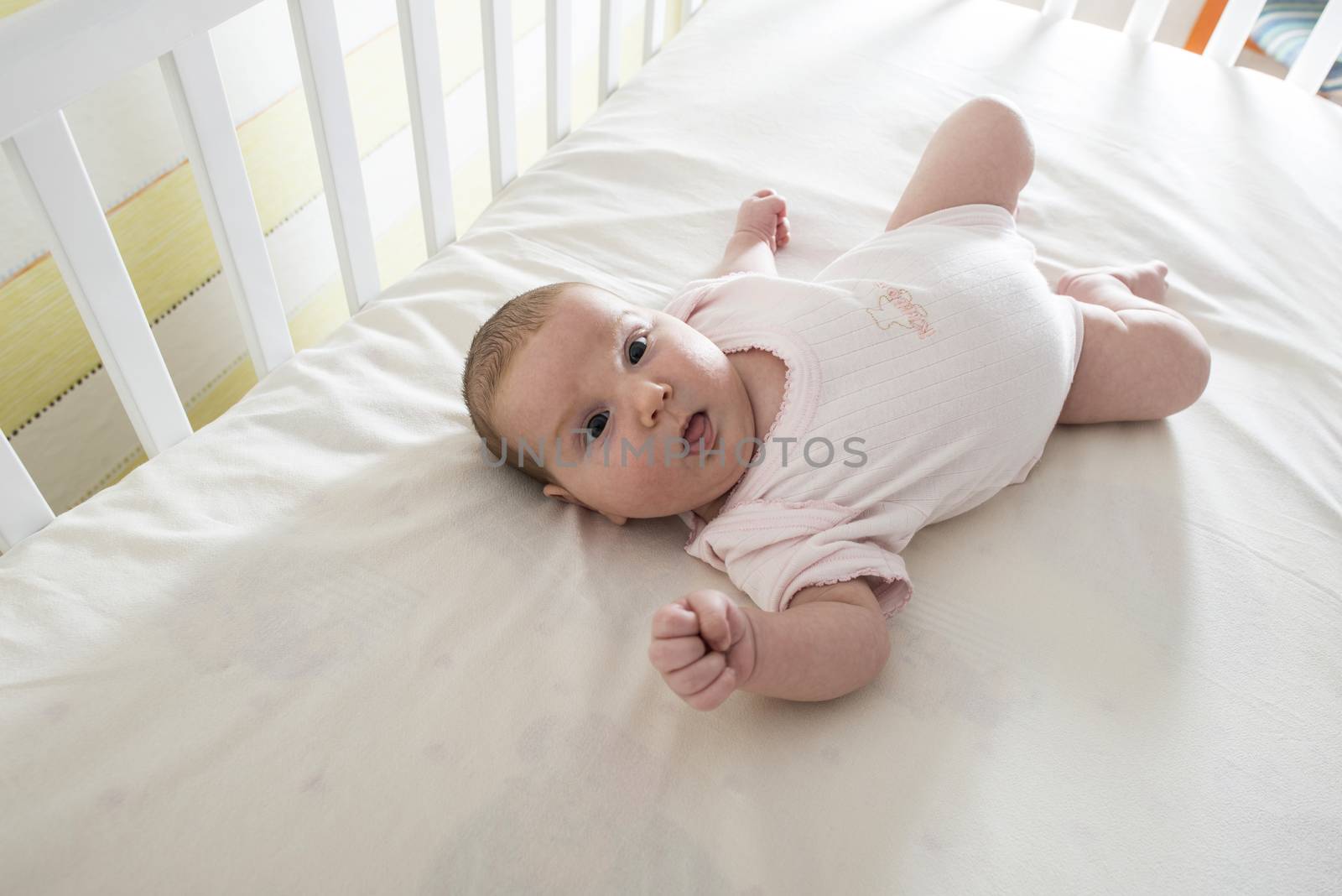 Baby in a baby bed by deyan_georgiev