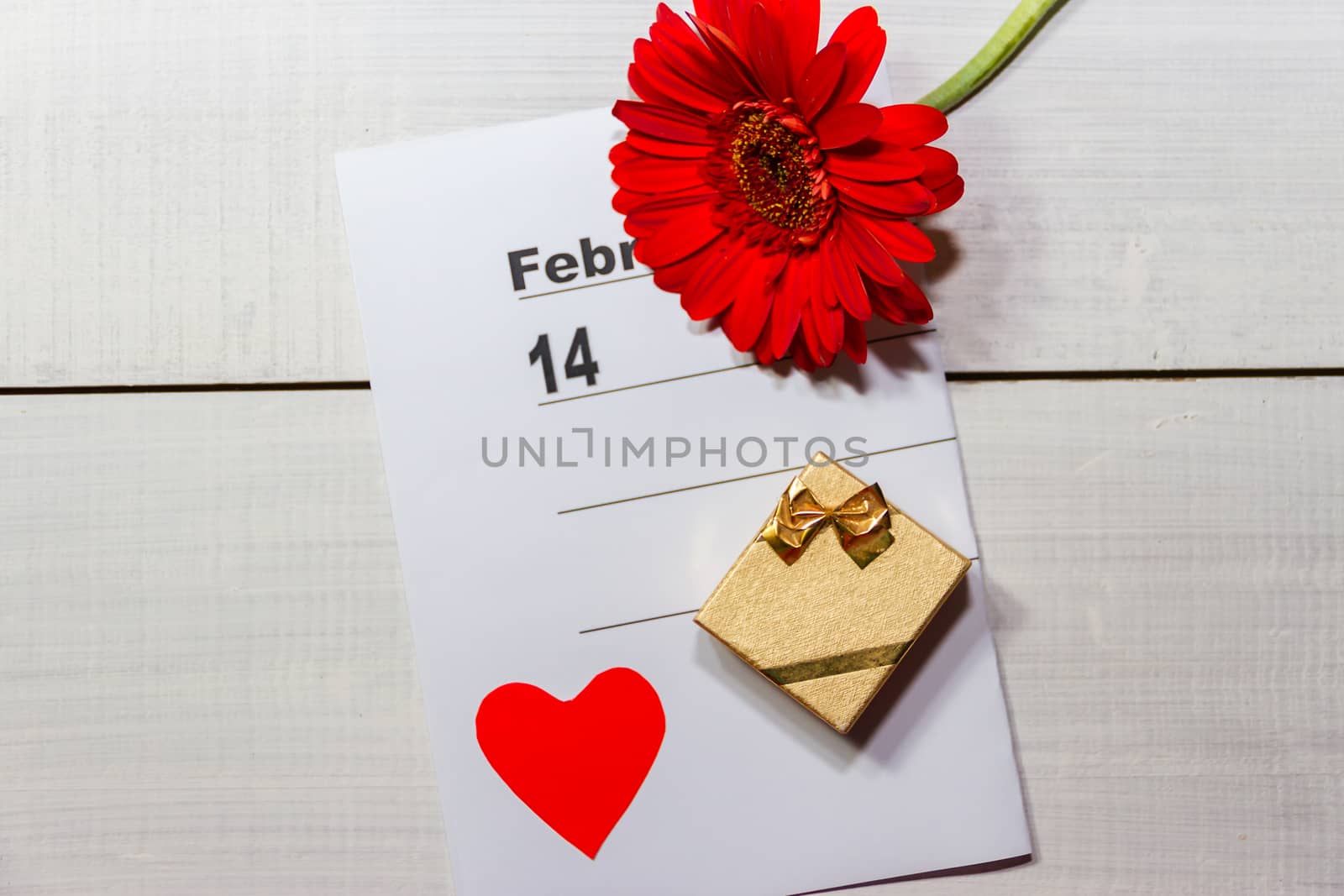 golden box with flower rings and note for valentines day