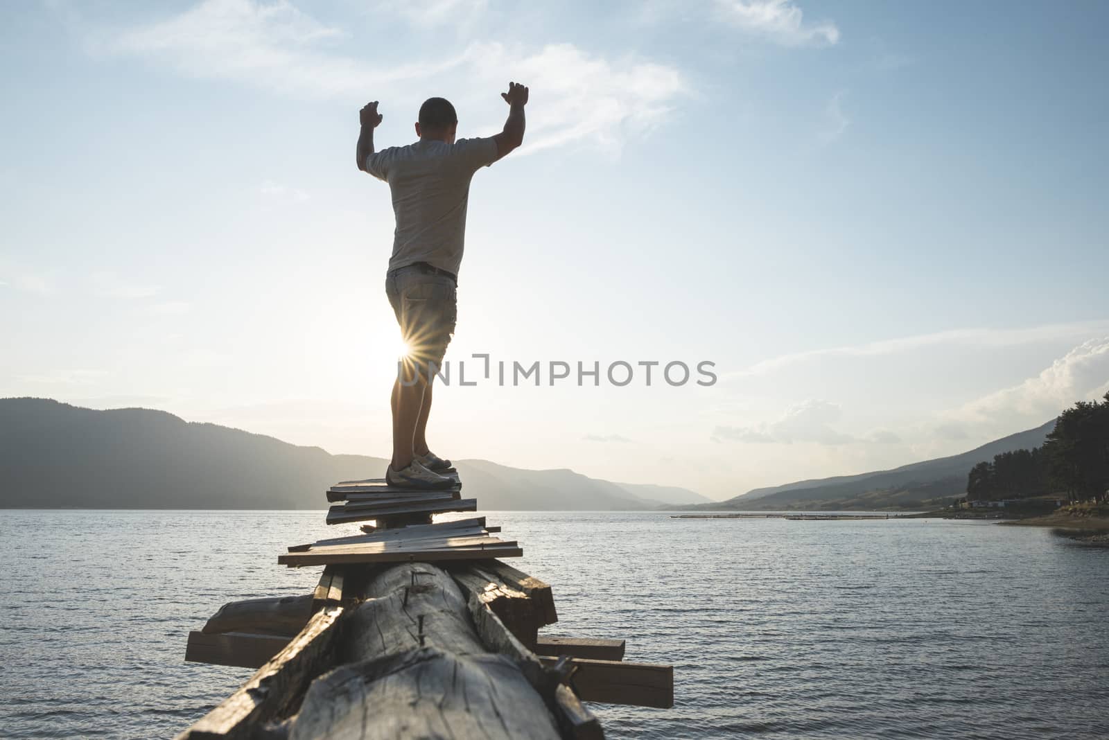 Boy in front of mountain lake by deyan_georgiev