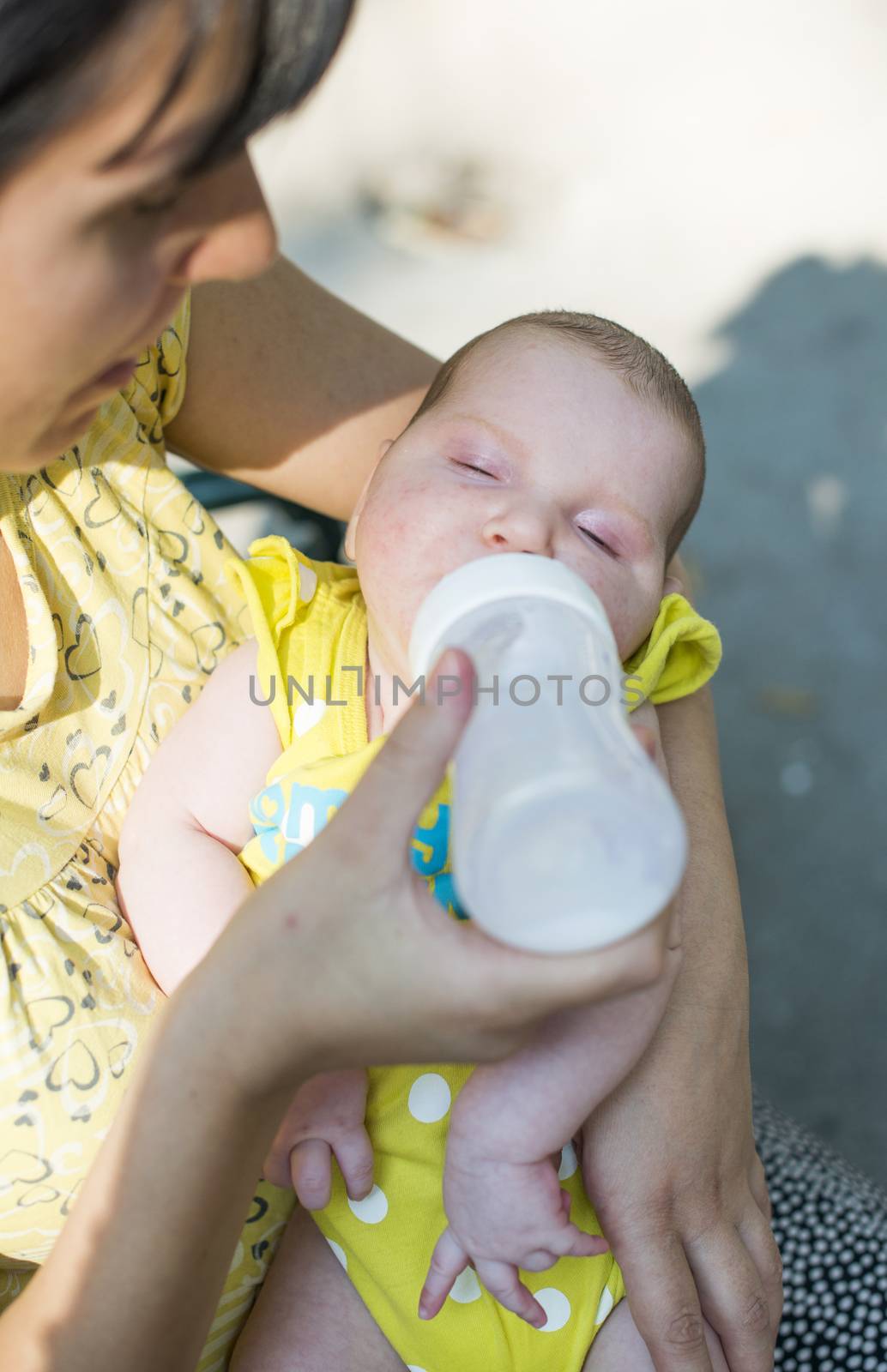 Baby sucks on a bottle by deyan_georgiev
