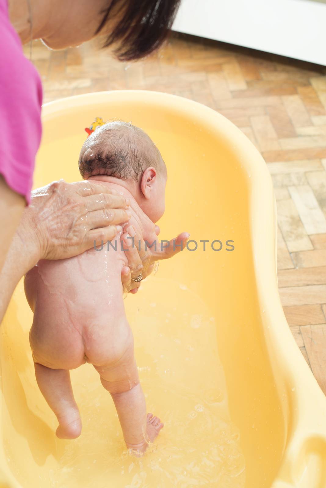 Bathing newborn baby. by deyan_georgiev