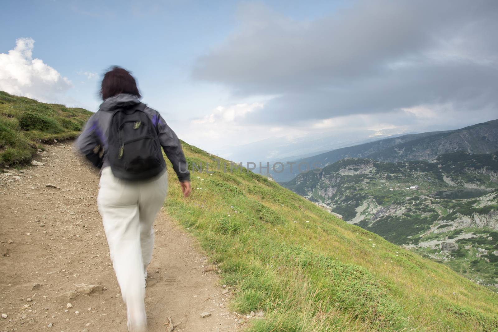 Senior woman walking in the mountain. 