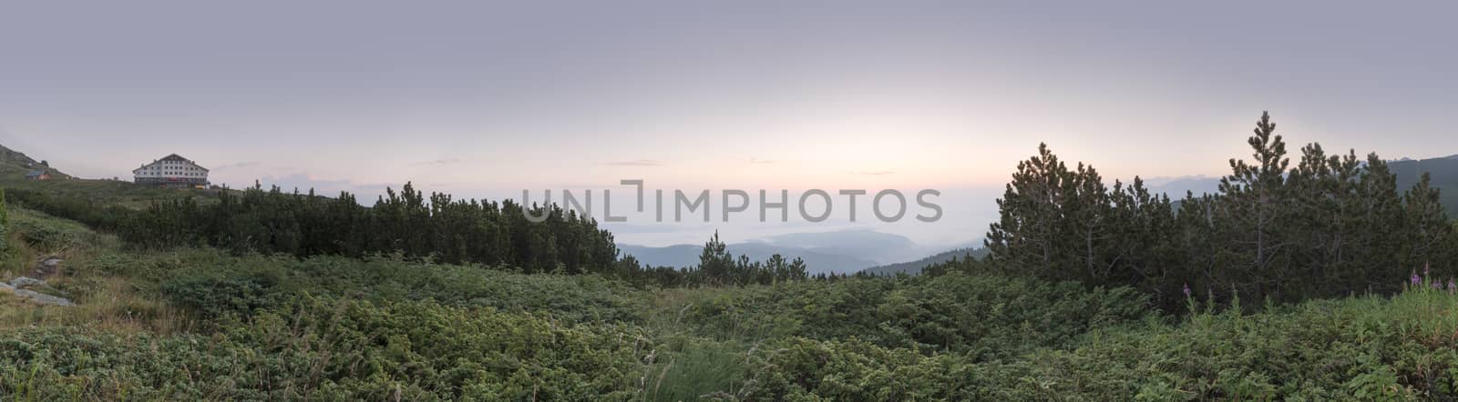 Sunrise in the mountain and hut. Panoramic image by deyan_georgiev
