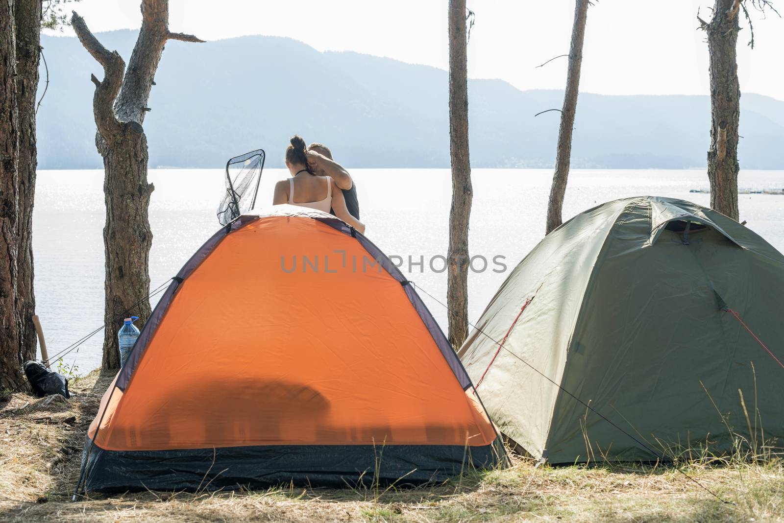Boy and girl on a campsite. Fishing