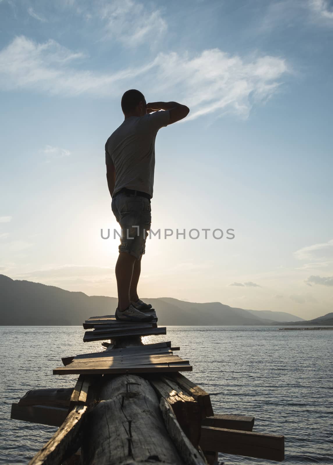 Boy in front of mountain lake by deyan_georgiev