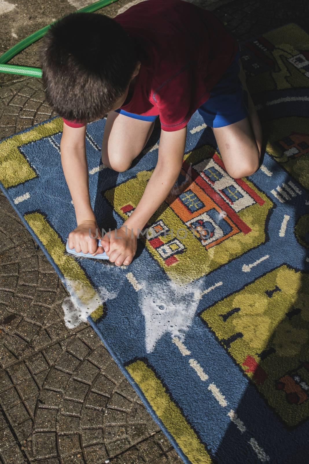 Child clean a carpet by deyan_georgiev