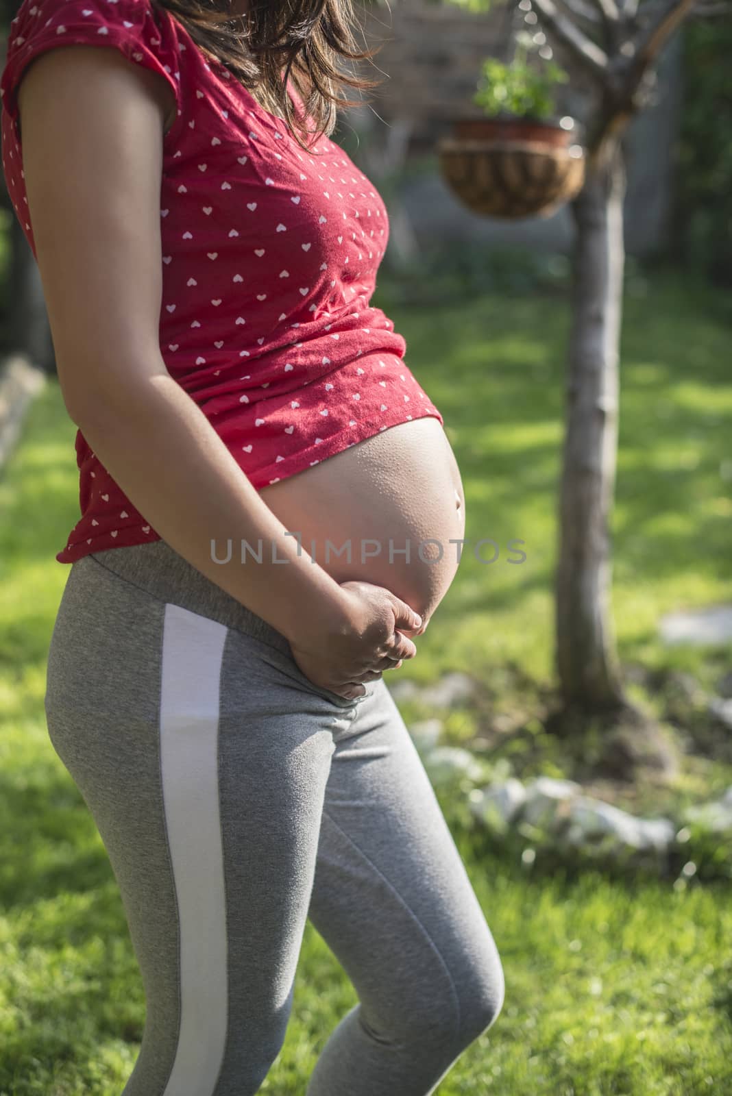 Pregnant woman shows his belly by deyan_georgiev