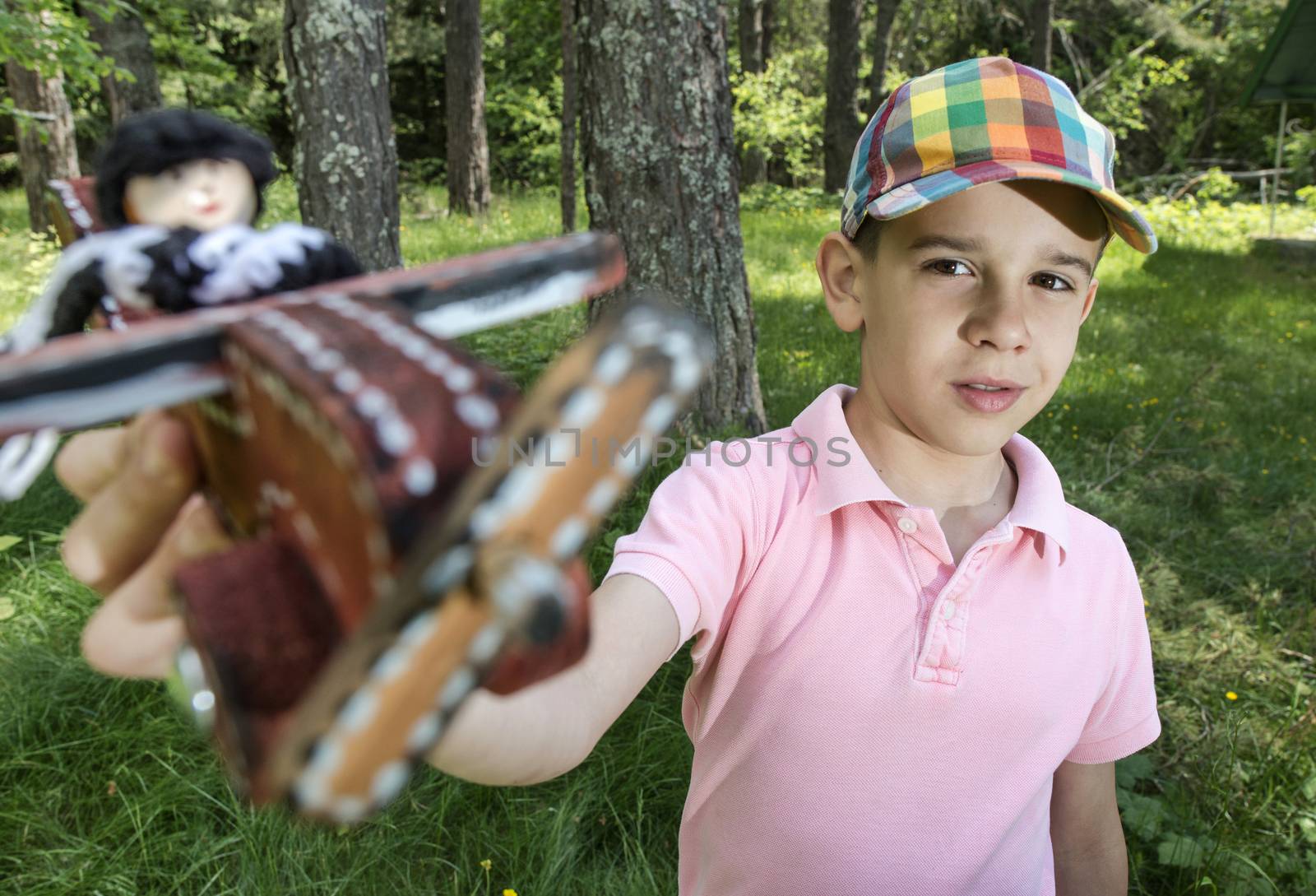 Child play with a wooden plane in the mountain. Forest