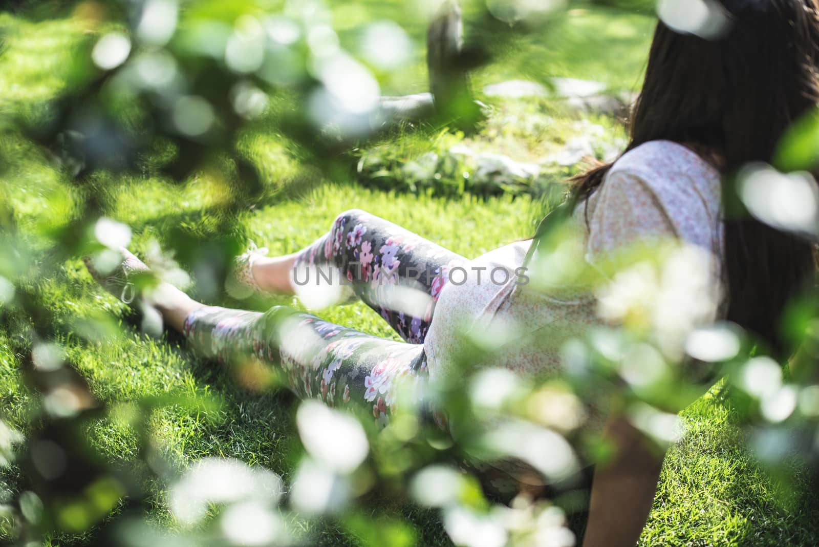 Pregnant women in the garden. Green grass