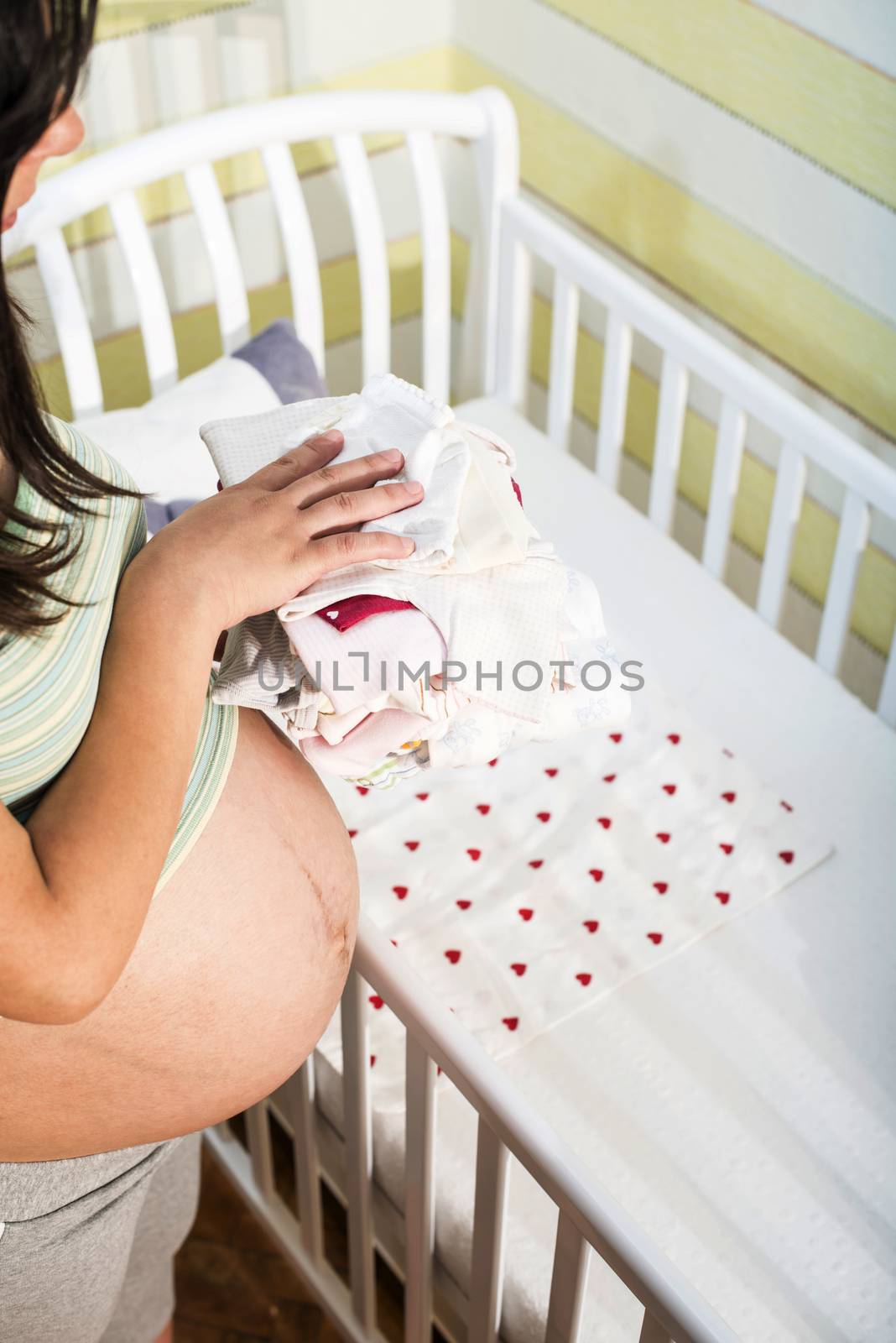 Pregnant women in a baby room. by deyan_georgiev