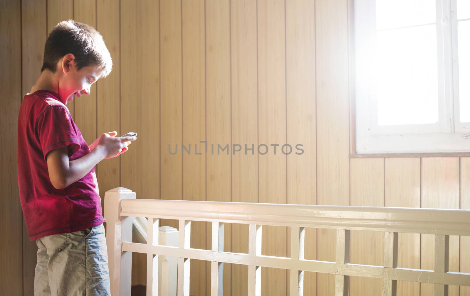 Child playing with phone by deyan_georgiev