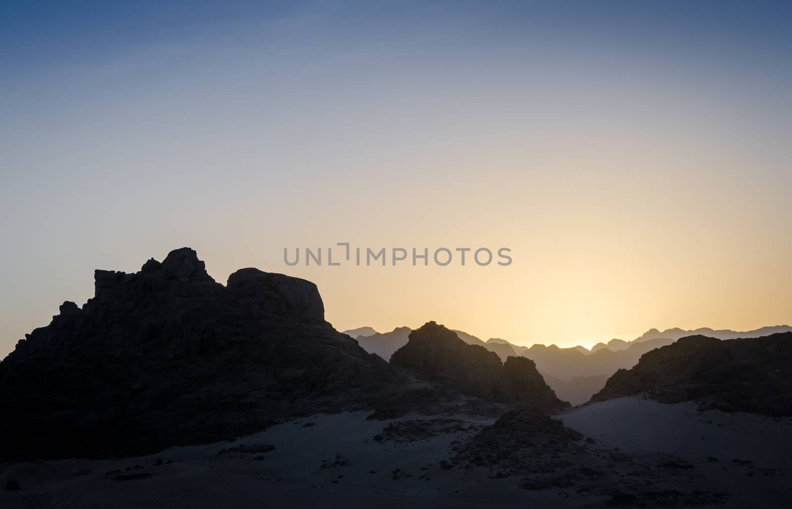 peaks of mountains in the desert of egypt against sunset