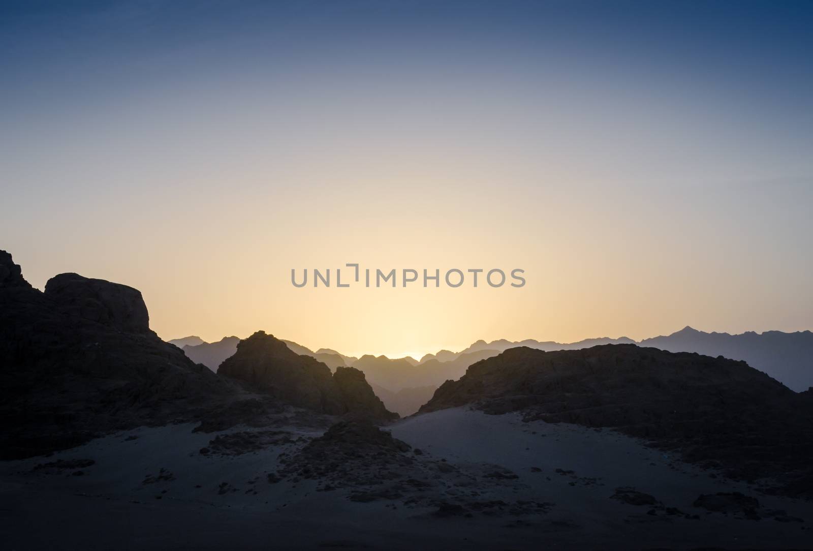 peaks of mountains in the desert of egypt against sunset