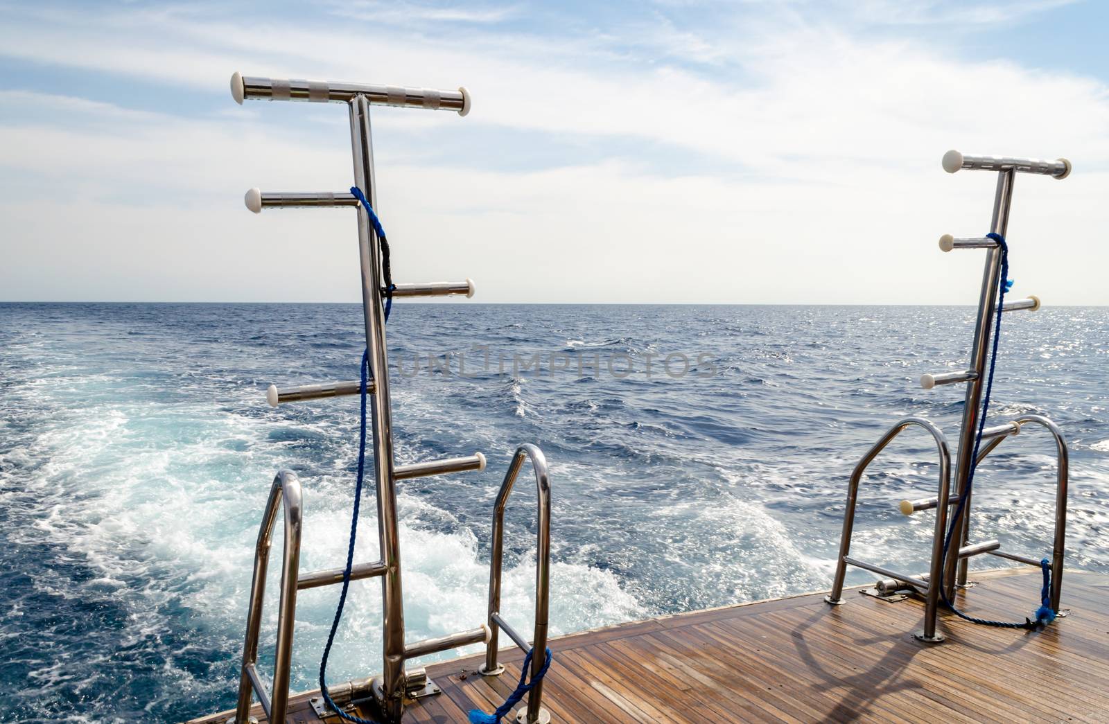 feed boats with raised ladders against the blue water of the Red Sea Egypt
