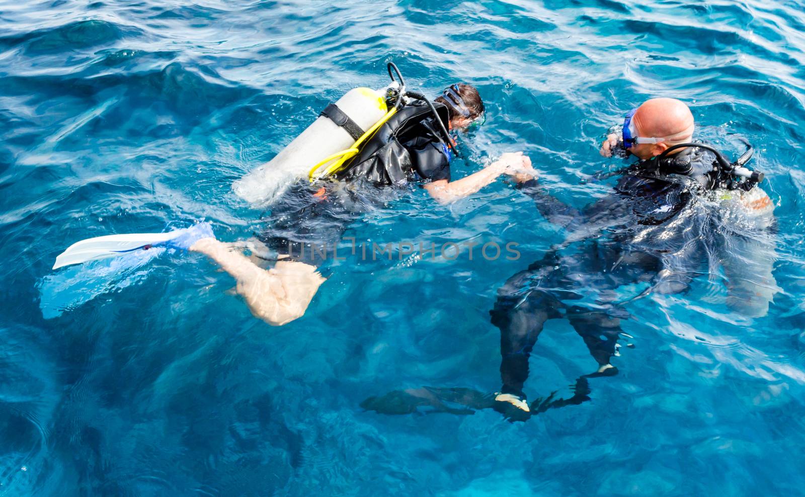 diver instructor teaches a beginner diver to dive in Egypt
