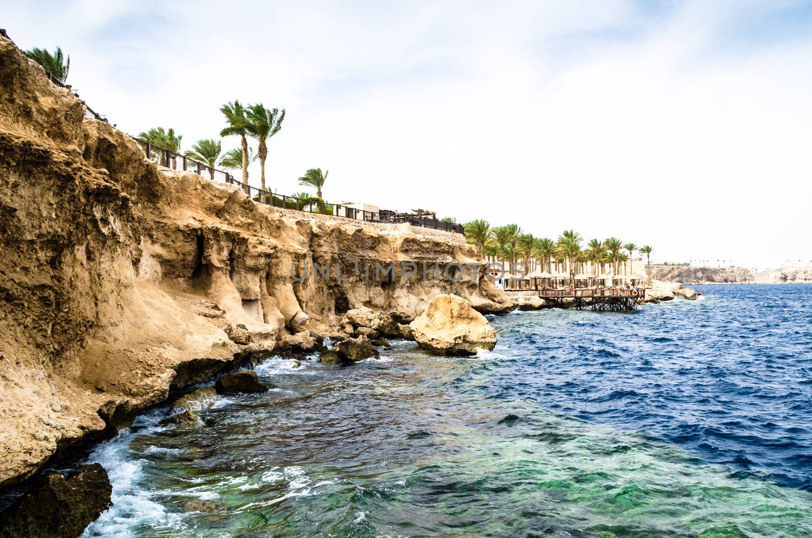 View from the sea to a rocky beach and a reef on the Red Sea coast