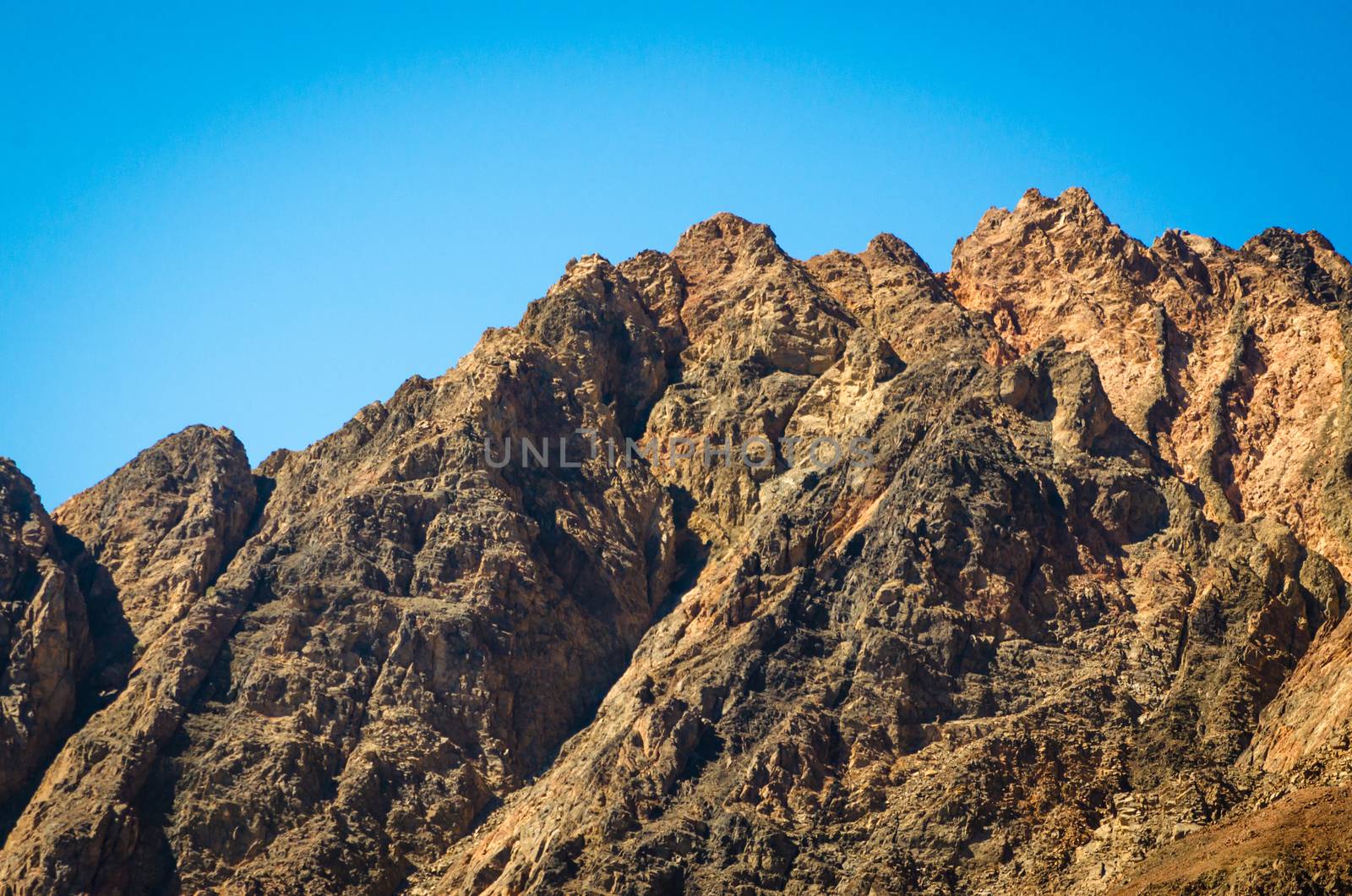 peaks of high rocky mountains against a blue sky in Egypt