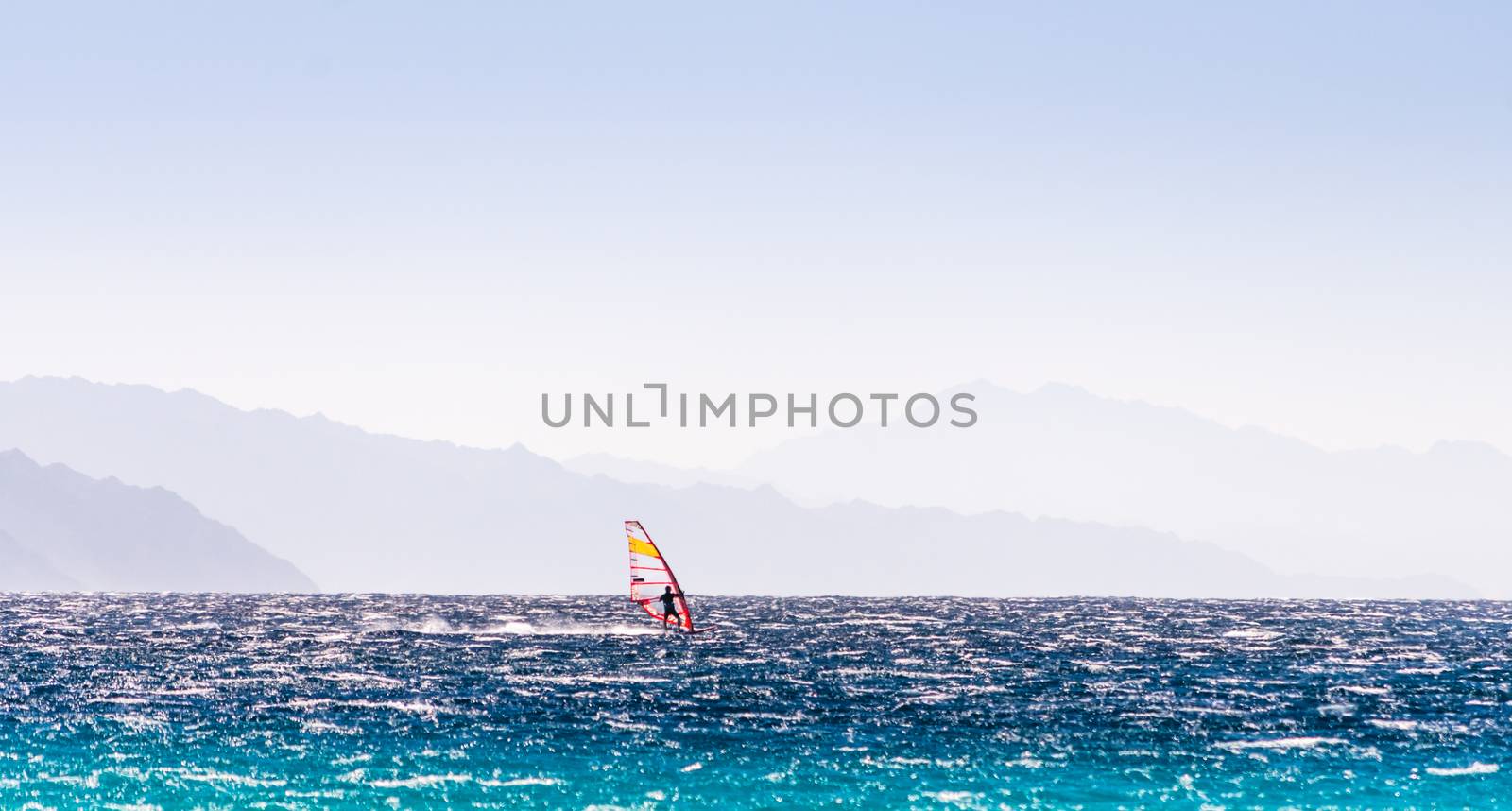 windsurfer rides on a background of high mountains in Egypt Dahab South Sinai