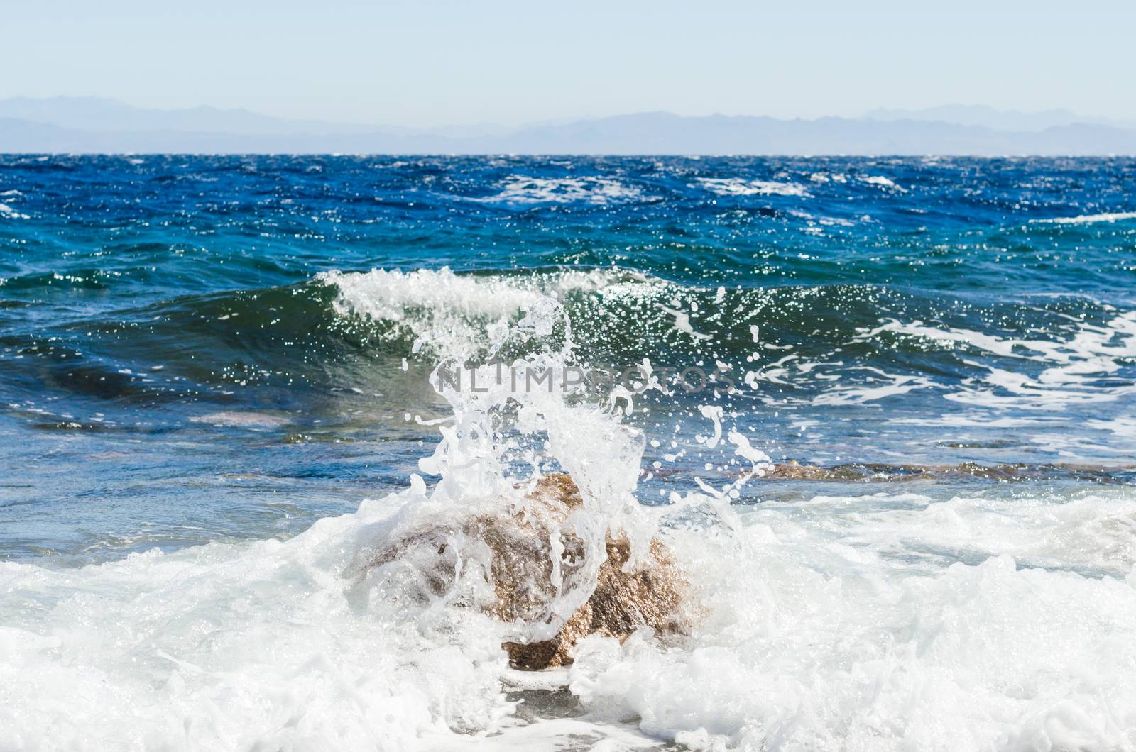 waves and splashes of sea surf and stones on the seashore