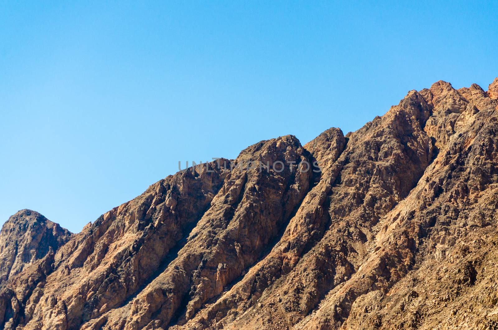 peaks of high rocky mountains against a blue sky in Egypt