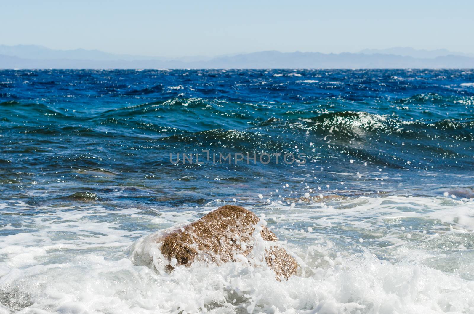waves and splashes of sea surf and stones on the seashore