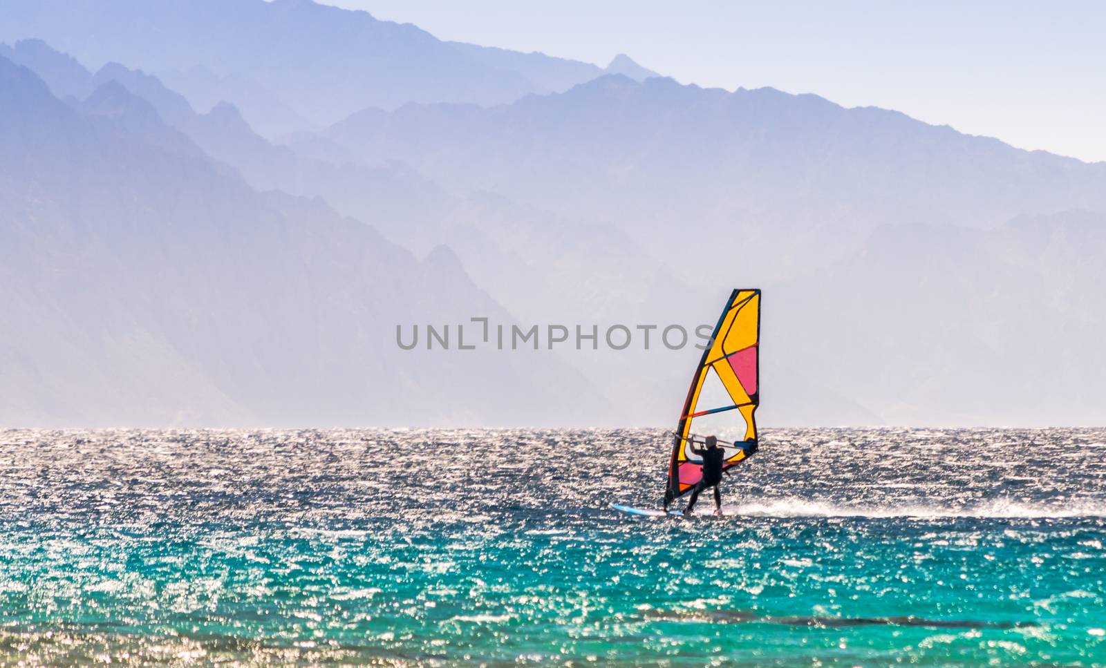 windsurfer rides on a background of high mountains in Egypt Dahab