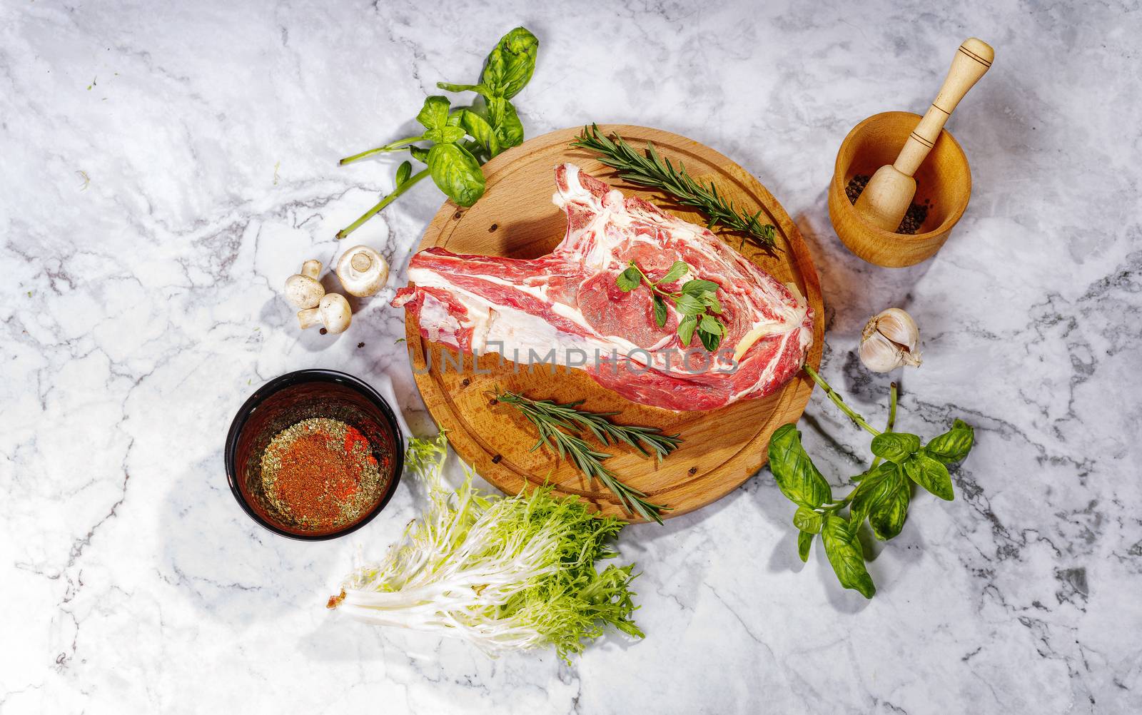 Raw marbled beef steaks with salt and spices on a marble background