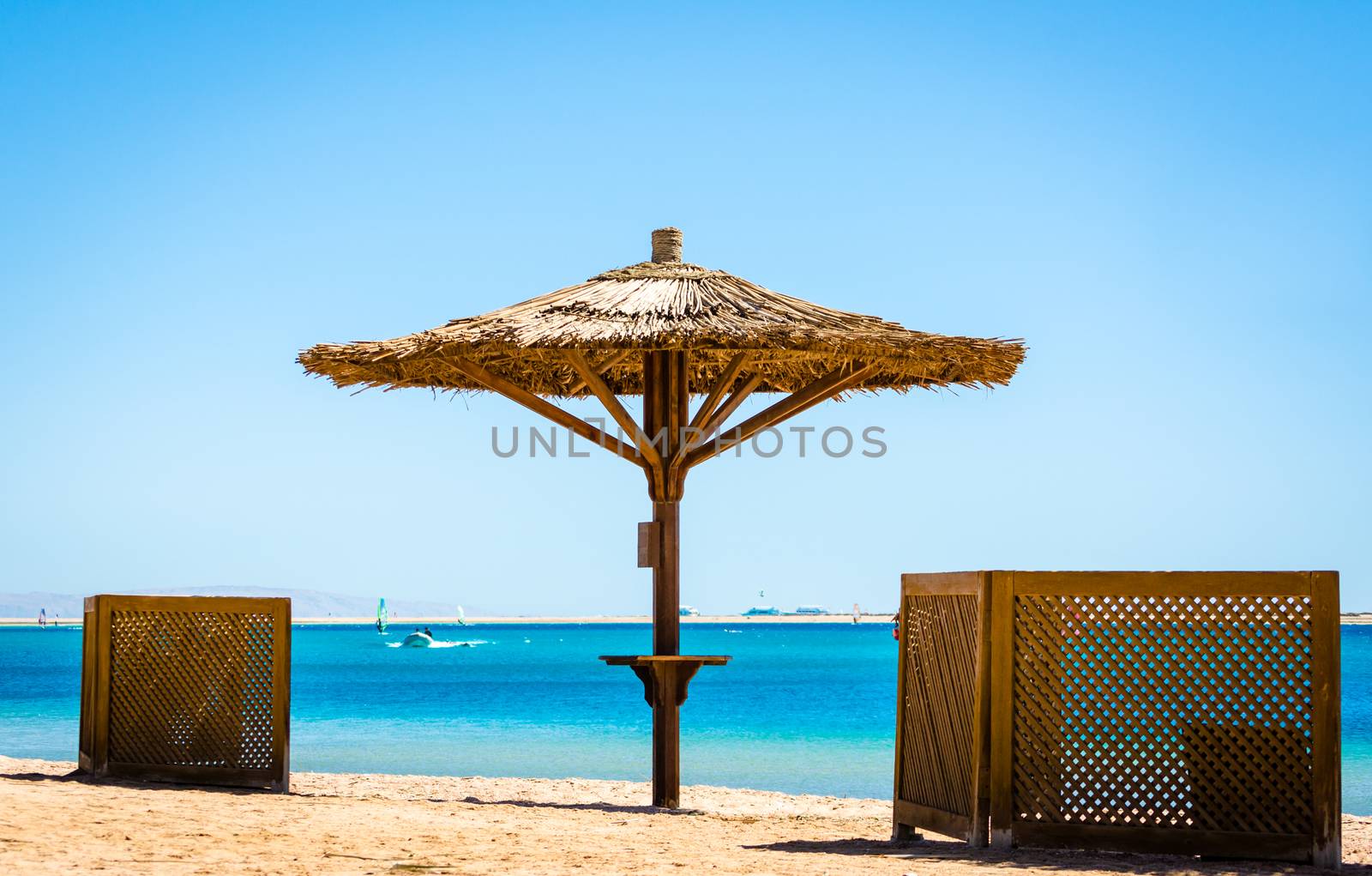 reed beach umbrella on the background of the sea and a clear sky in Egypt