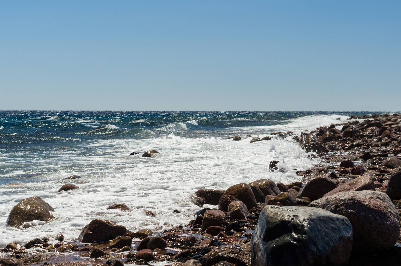 waves and splashes of sea surf and stones on the seashore