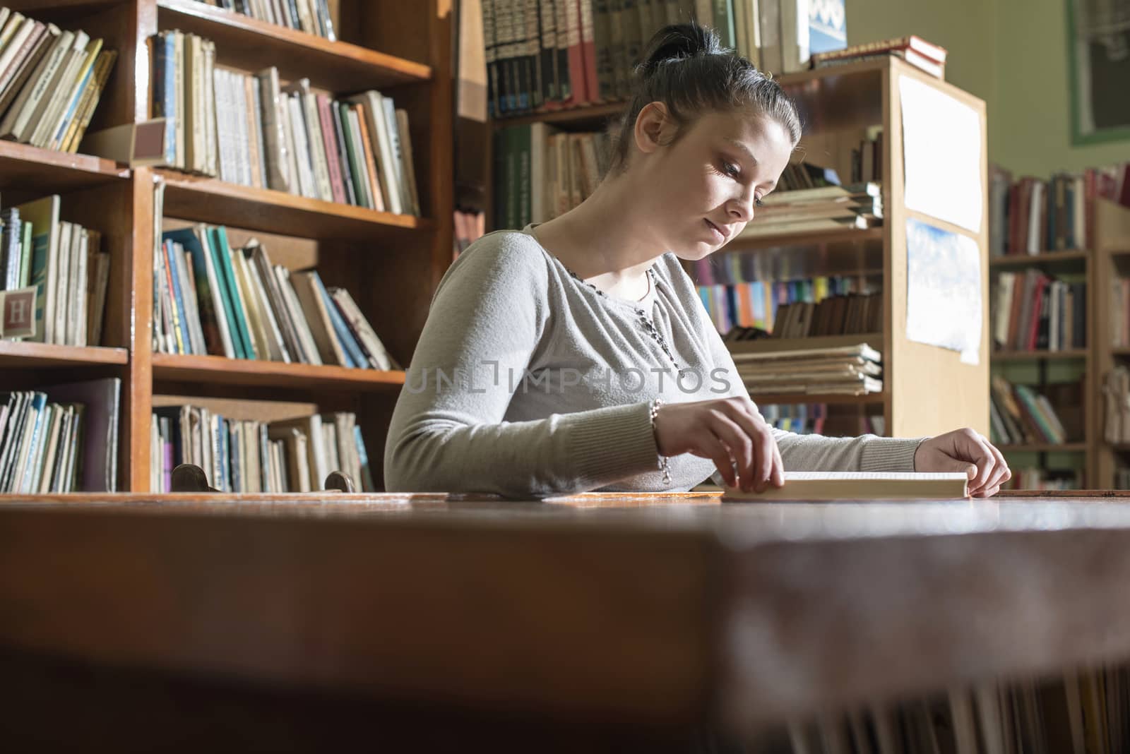 Young women in a vintage library by deyan_georgiev