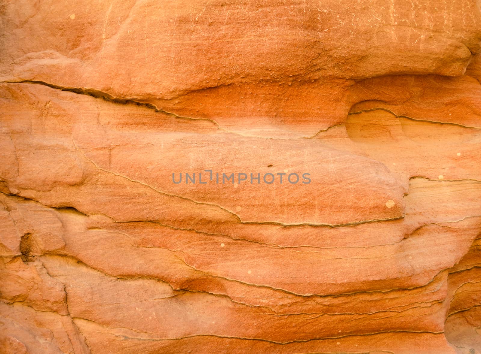 texture of orange stone rock in a colored canyon closeup