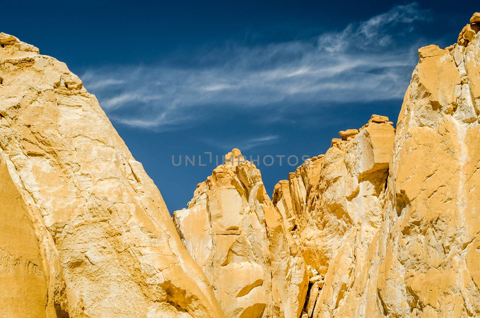 high rocky mountains against the blue sky and white clouds in the desert in Egypt Dahab South Sinai