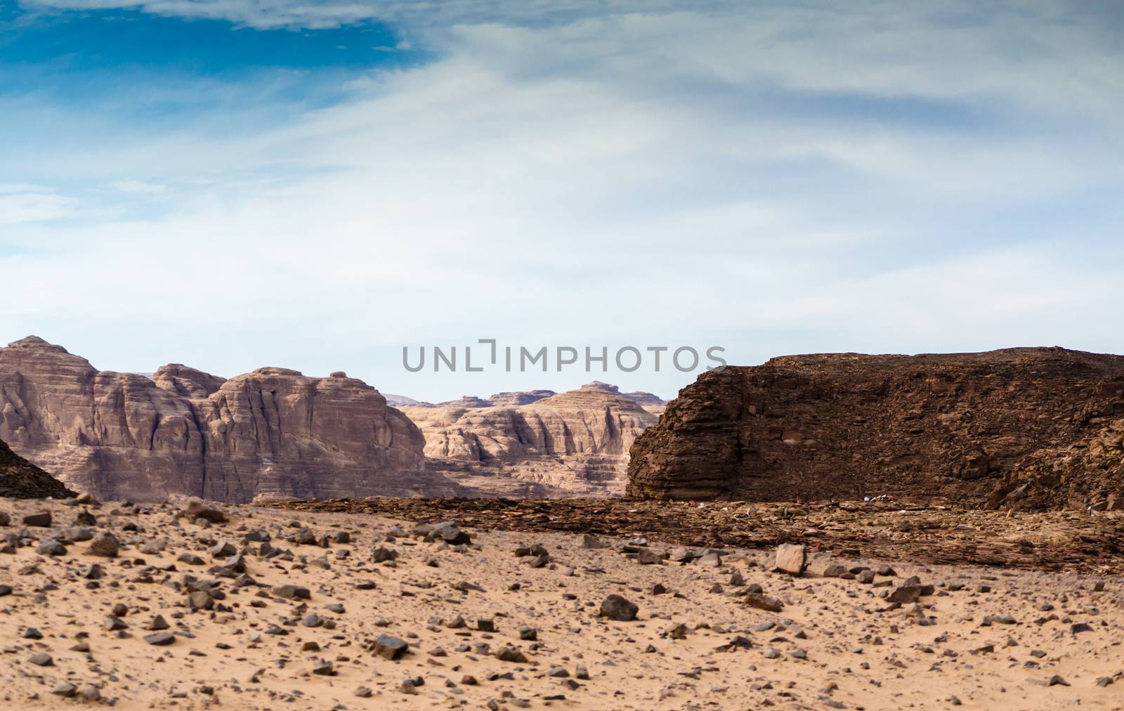 mountains in the desert against the blue sky and white clouds