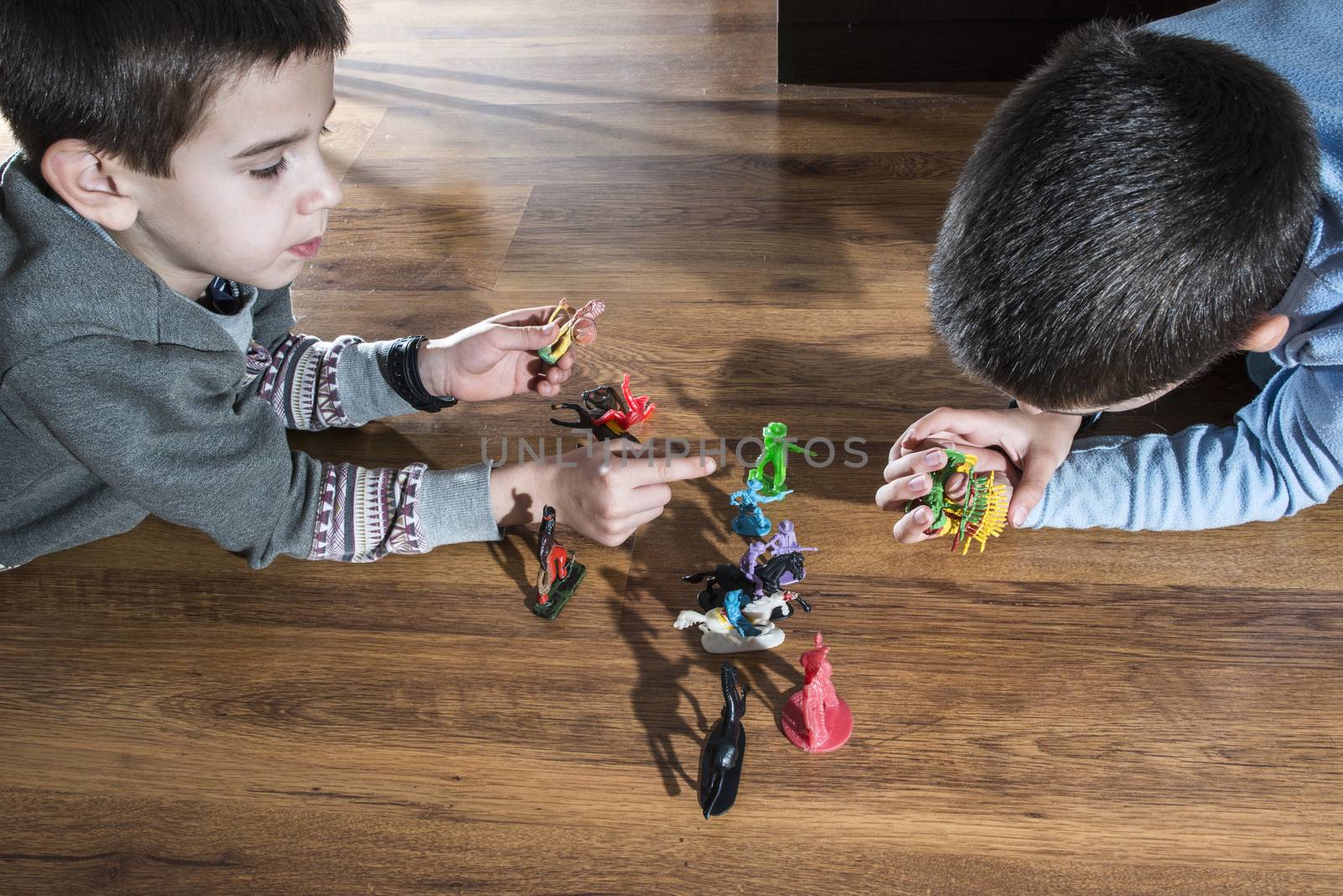 Childs playing with small vintage toys on the floor