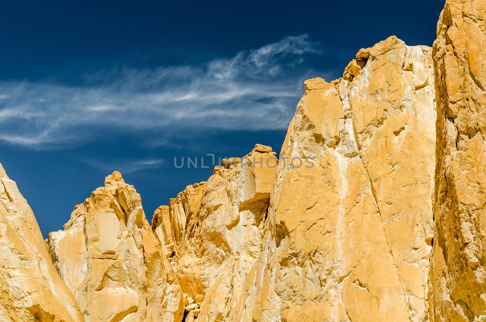 high rocky mountains against the blue sky and white clouds in the desert in Egypt Dahab South Sinai