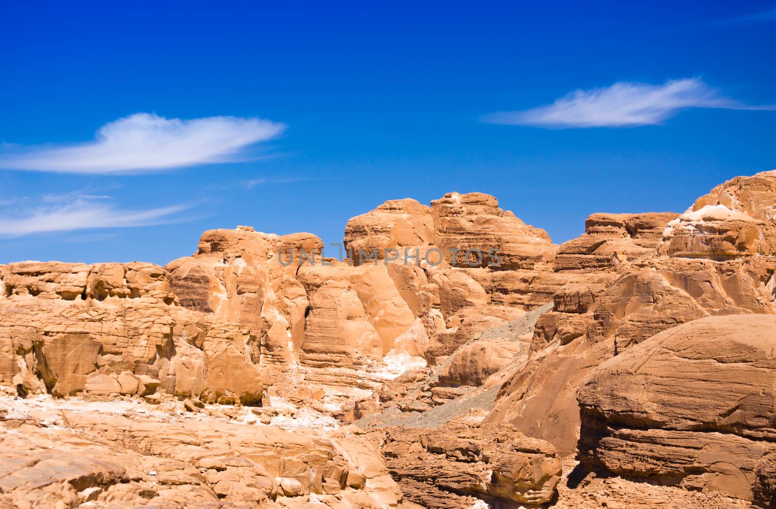 peaks of high stone rocks against a blue sky in Egypt Dahab
