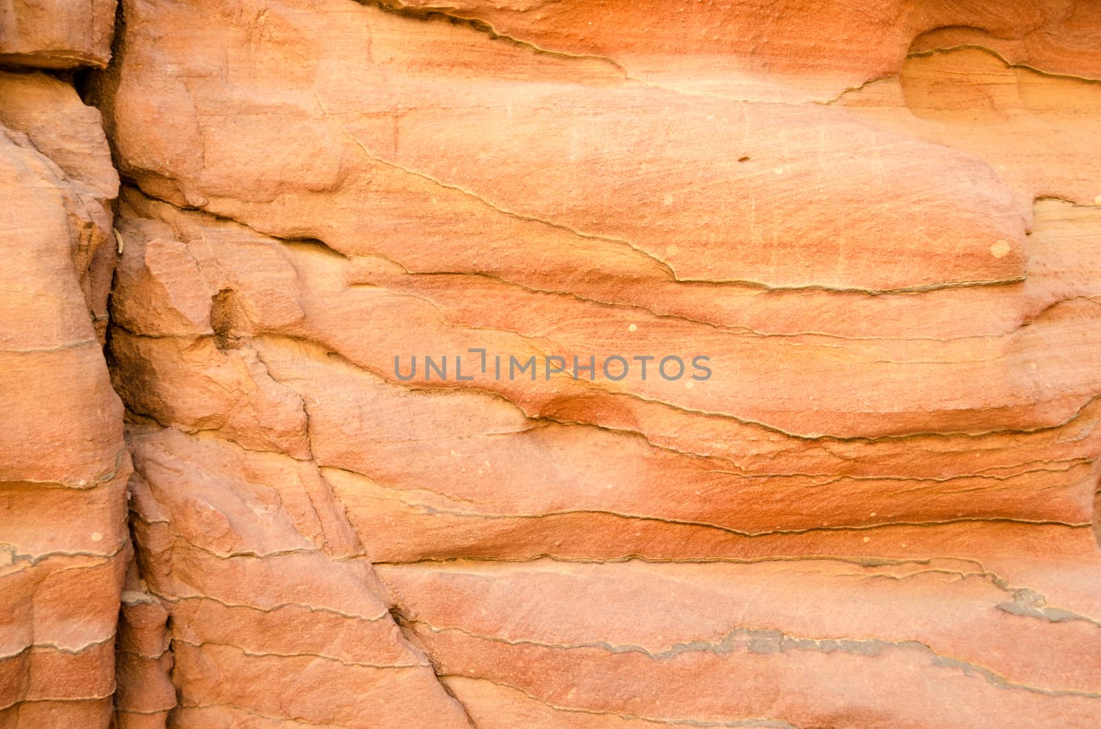 texture of orange stone rock in a colored canyon closeup