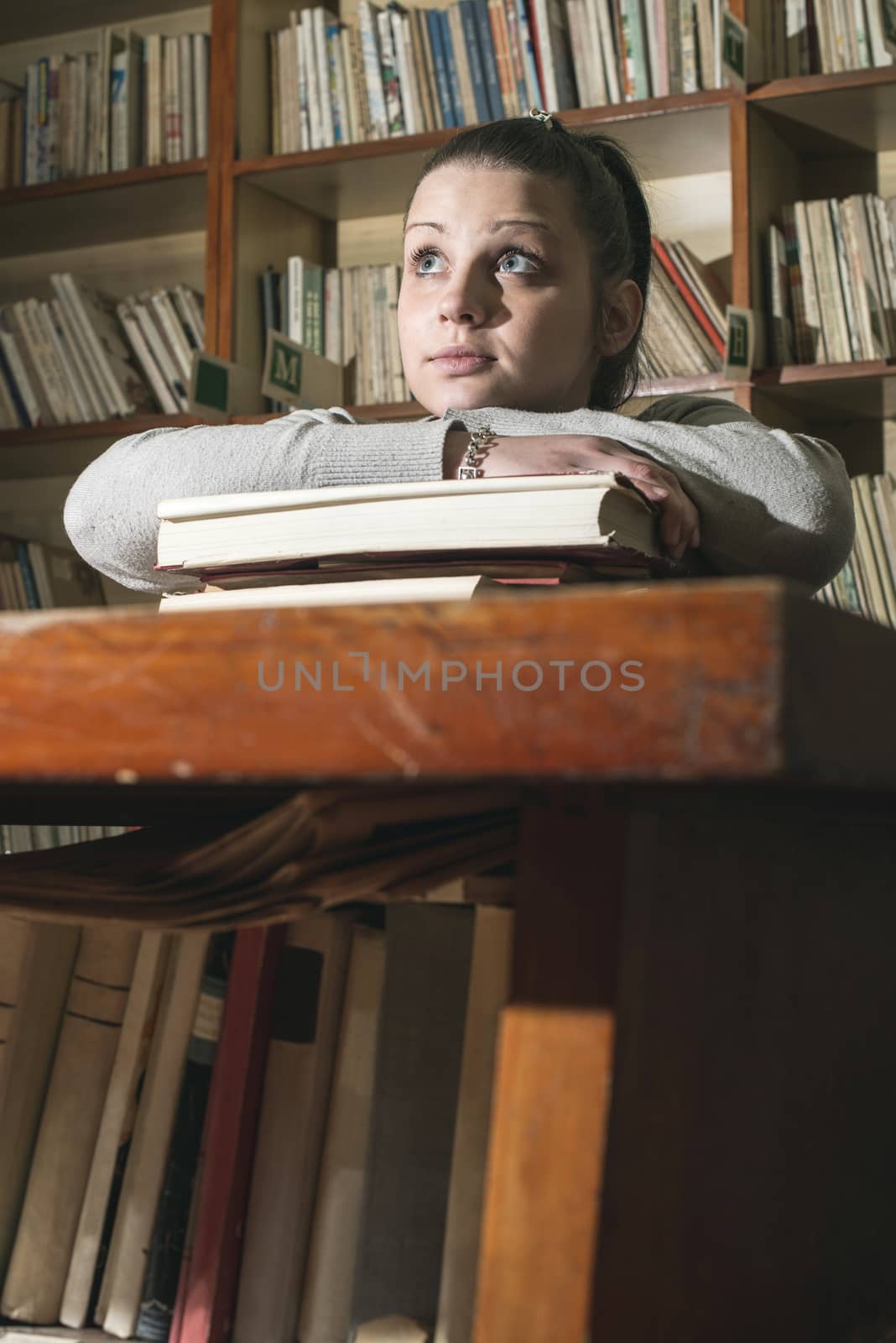 Young women in a vintage library by deyan_georgiev
