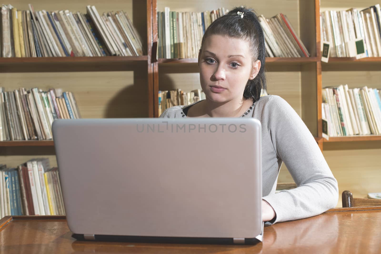 Student girl and laptop in a vintage library