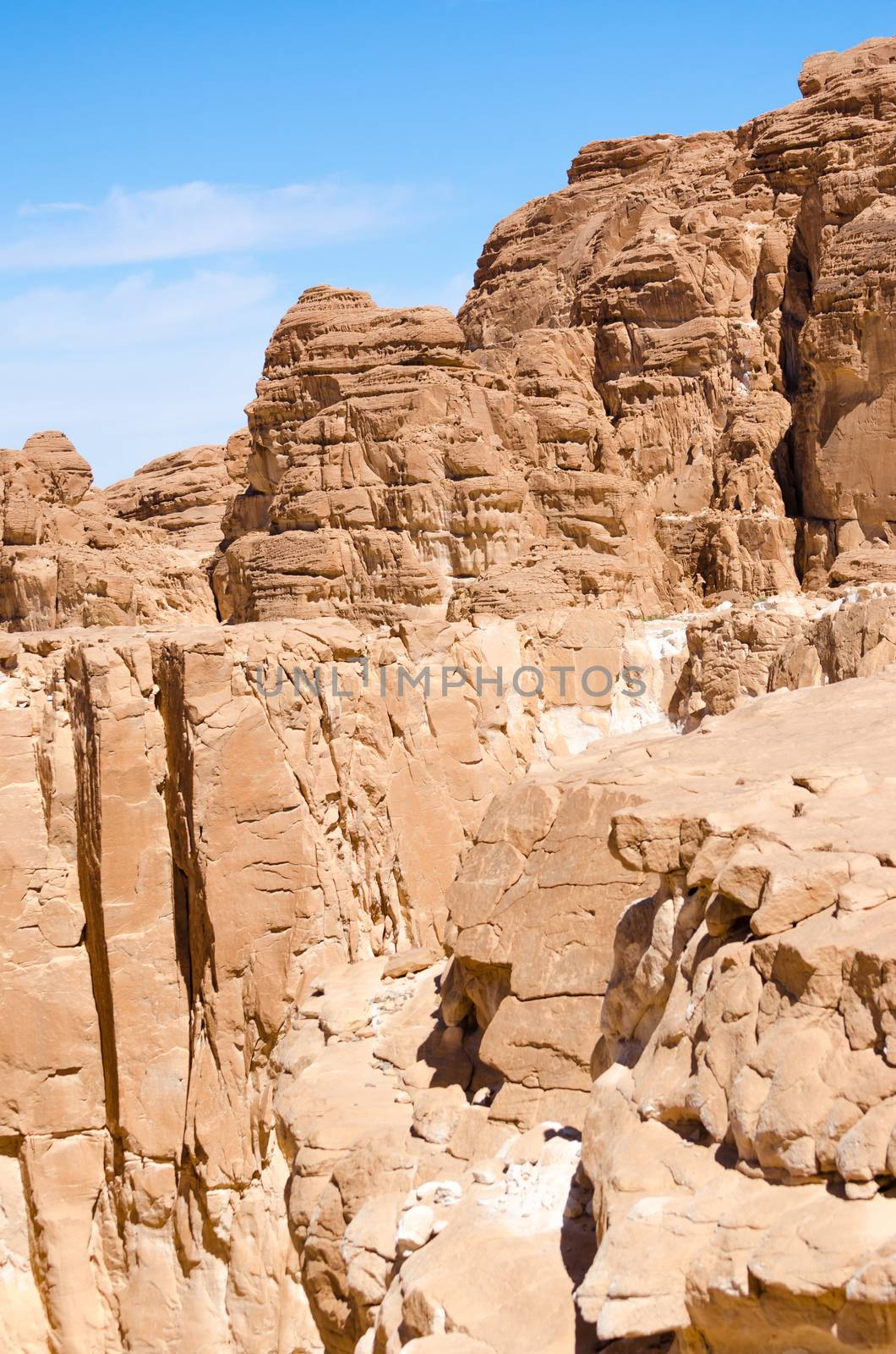 high rocky mountains against the blue sky and white clouds in the desert in Egypt Dahab South Sinai