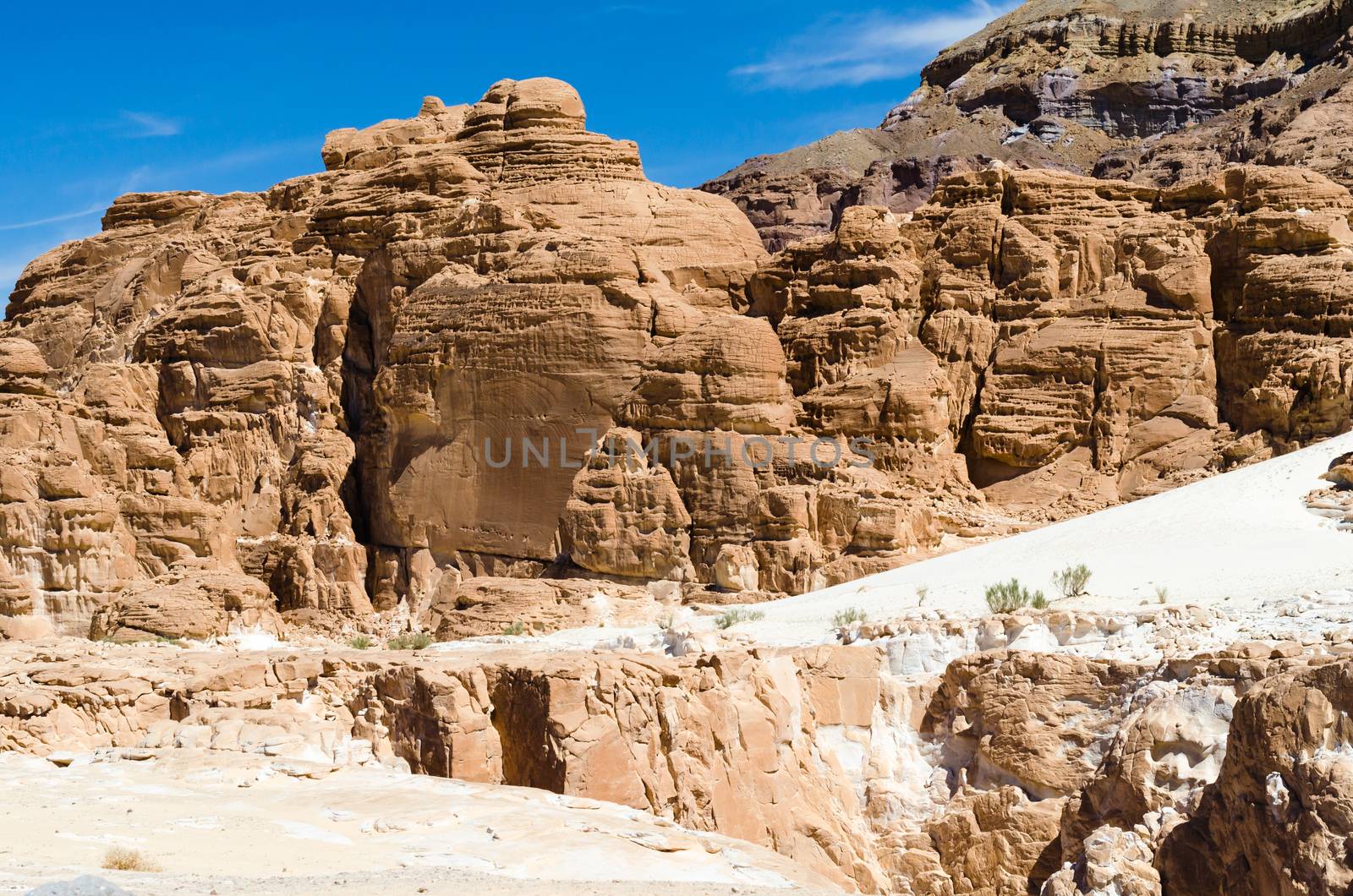 high rocky mountains against the blue sky and white clouds in the desert in Egypt Dahab South Sinai