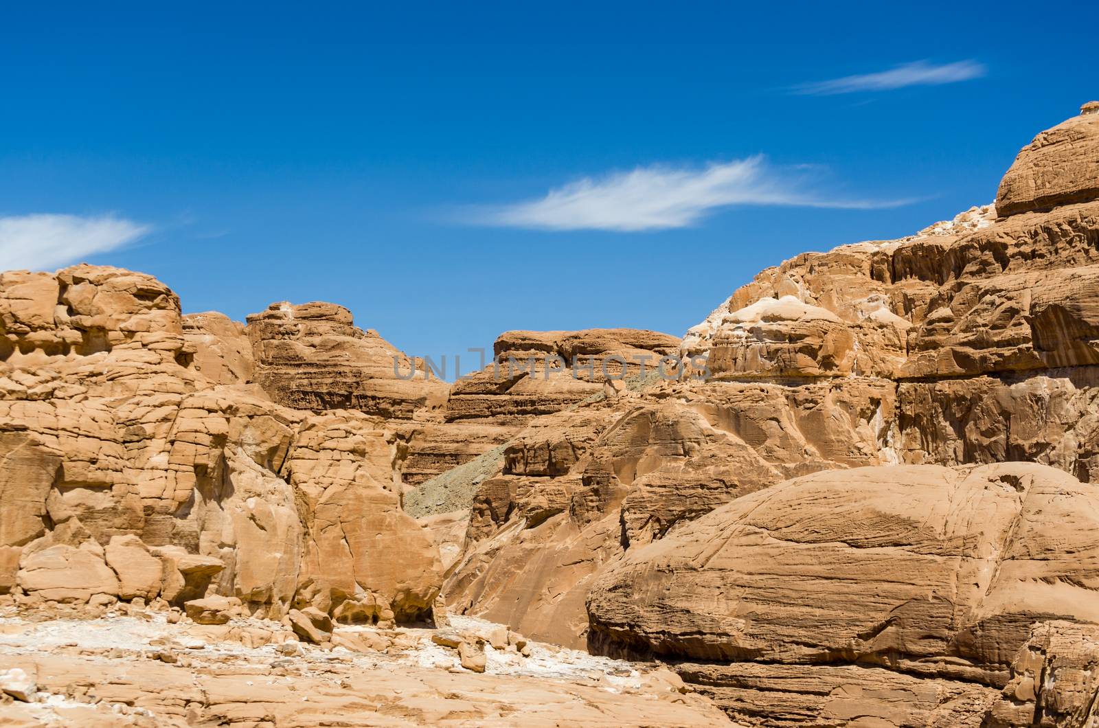 high rocky mountains in the desert against the blue sky and white clouds in Egypt Dahab