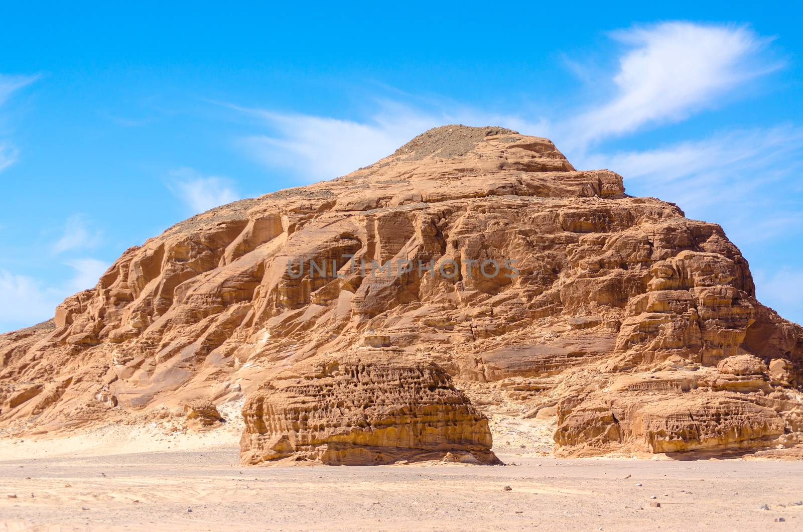 high rocky mountains against the blue sky and white clouds in the desert in Egypt Dahab South Sinai