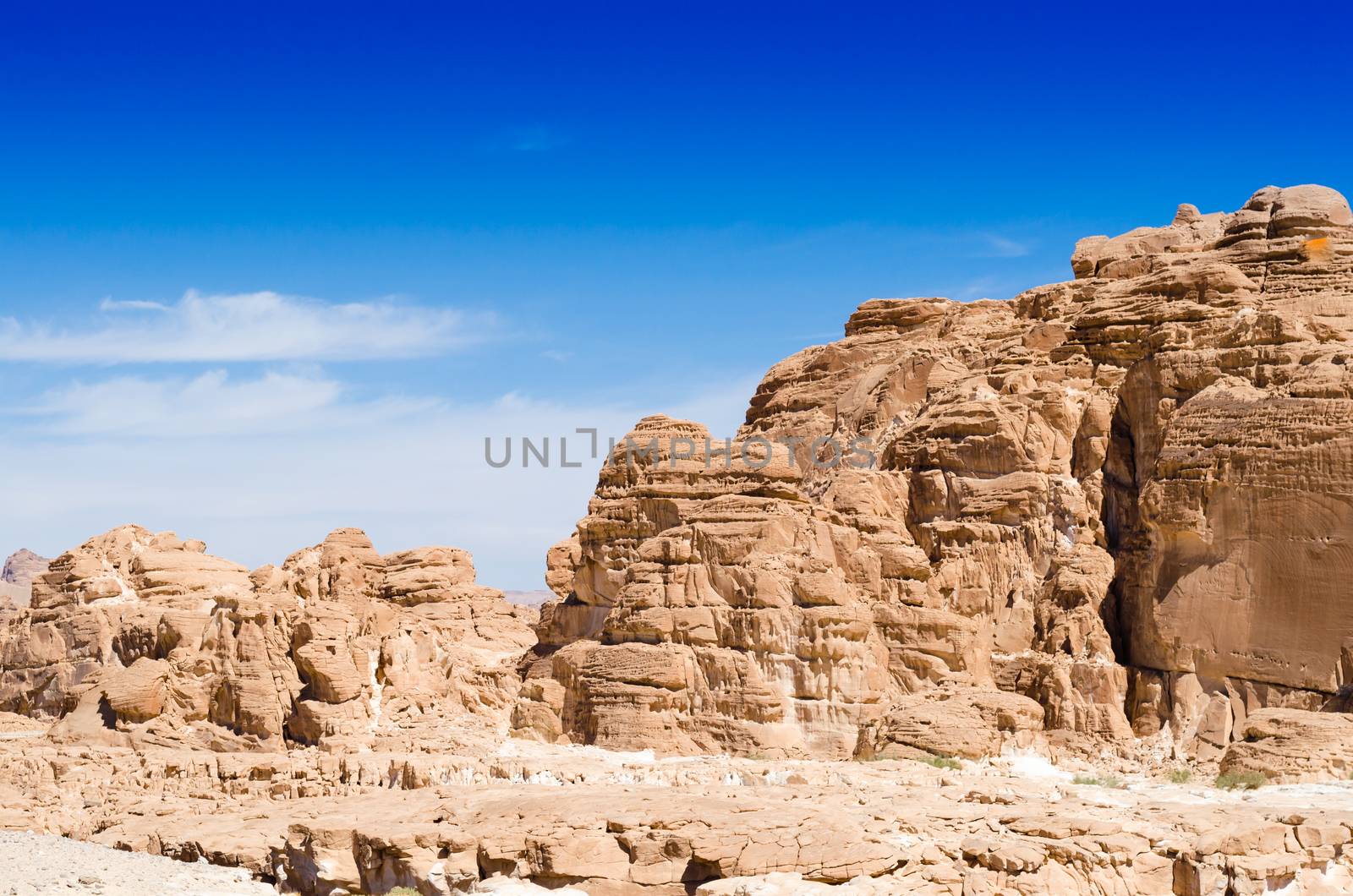 high rocky mountains against the blue sky and white clouds in the desert in Egypt Dahab South Sinai