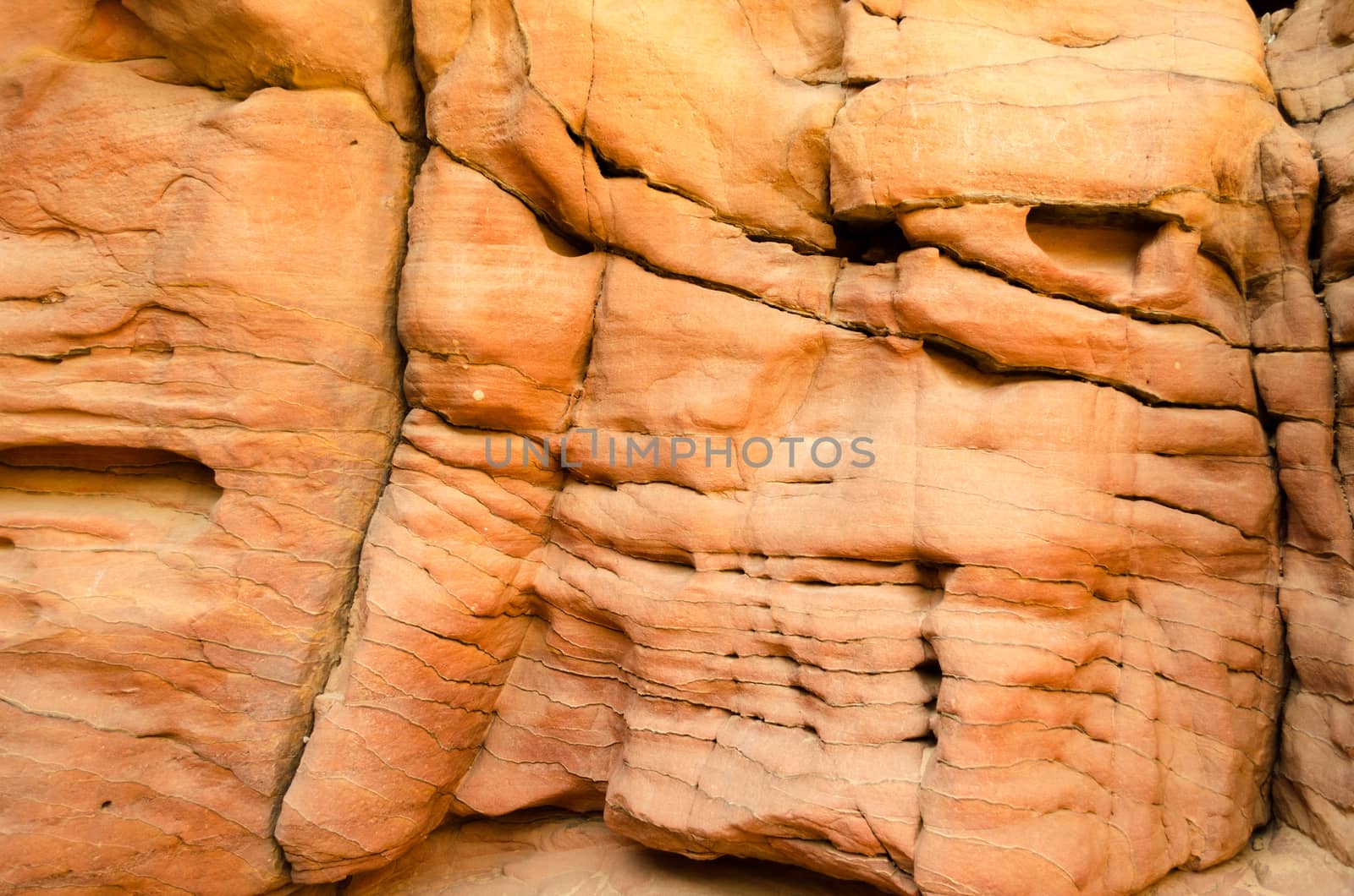 texture of orange stone rock in a colored canyon closeup