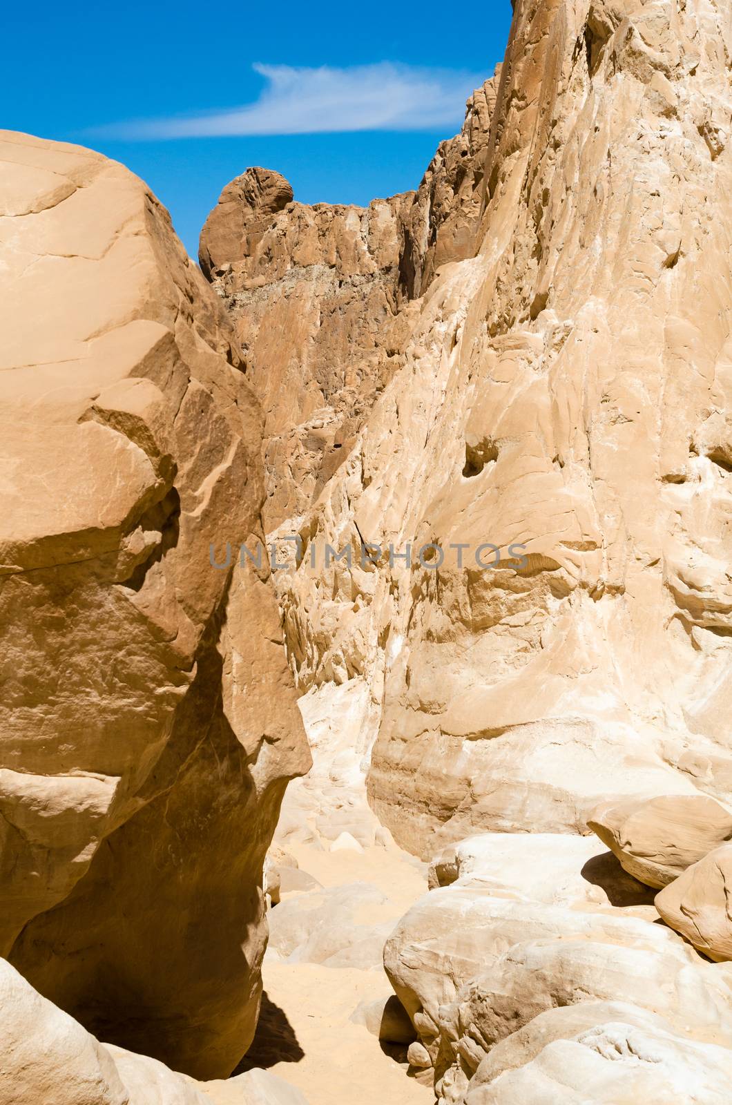 high rocky mountains against the blue sky and white clouds in the desert