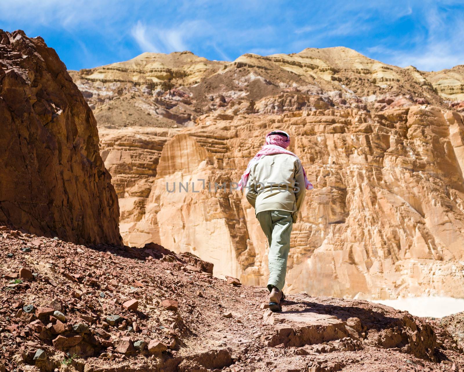 Bedouin climbs a mountain in a canyon in Egypt Dahab